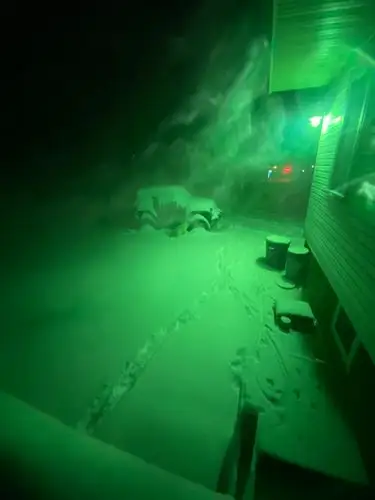 Eerie green light transforms this snowy winter night.